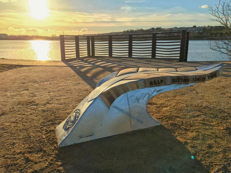 Giant leaf bench on the bank of the Plym Estuary | Plymouth | Thrussells sunsets over the Plym Estuary with a giant leaf bench by the waters side. Plymouth public art