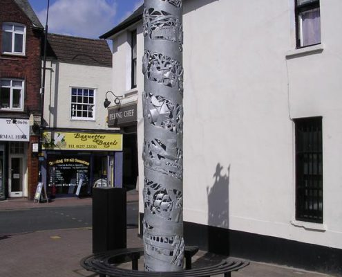 Brentwood Town Heritage Sculpture | Brentwood, Essex | Thrussells Metal column heritage sculpture with wrap around seat. made by Thrussells. Public Art Essex