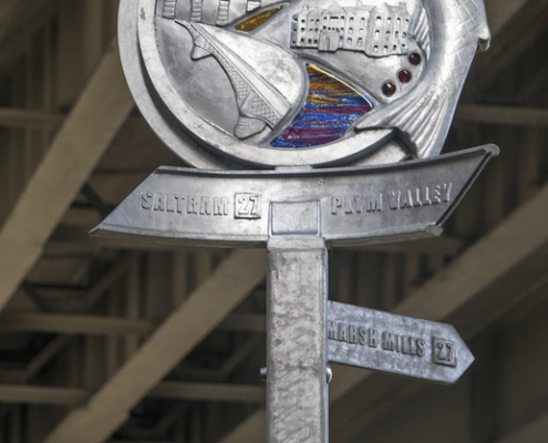 Waymarker Plym Valley Heritage Trail rainbow glass. Marsh Mills A38 flyover | Plymouth | Thrussells Waymarker sign made of metal and rainbow glass. Fish and railway themed. Plymouth public art