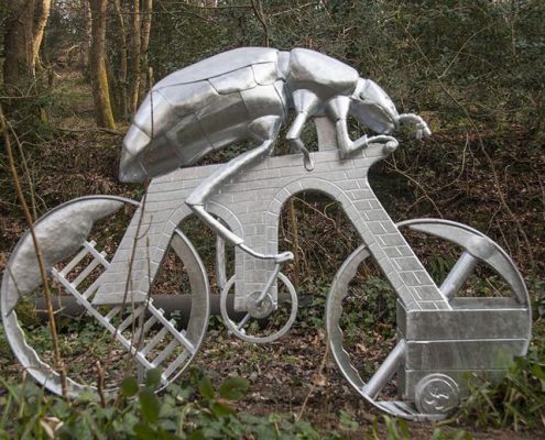 'Beetle On A Bike' feature sculpture at Plym Bridge | Plymouth | Thrussells sculpture of a giant beetle riding a bike through a woodland. Made from steel by Thrussells. Plym Valley Trail. Plymouth public art