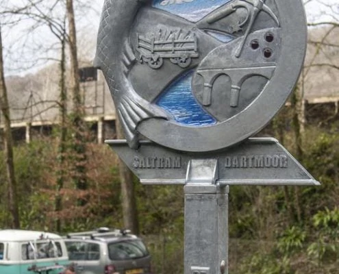Waymarker Plym Valley Heritage Trail blue sky glass. Plym Bridge | Plymouth | Thrussells Waymarker sign made of metal and blue glass. Fish and railway themed. Plymouth public art