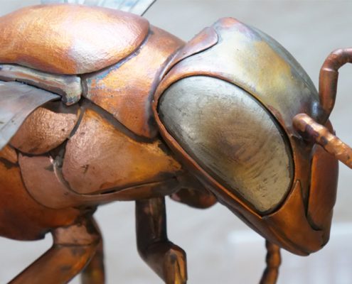 Copper and Stainless Steel giant Bee sculpture | Thrussells Upclose with a giant bee sculpture head and torso, made from copper and stainless steel.