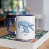 Two tone white and navy blue mug with Thrussells blue bird on book