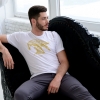Man sitting with white t-shirt with Thrussells yellow bird